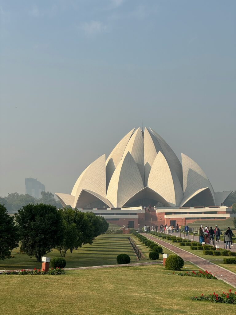 Lotus Temple Delhi exterior view with surrounding gardens and landscape setting