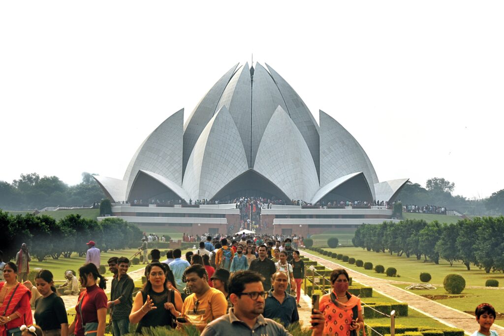 Lotus Temple Delhi wide establishing shot with visitors and crowds for scale
